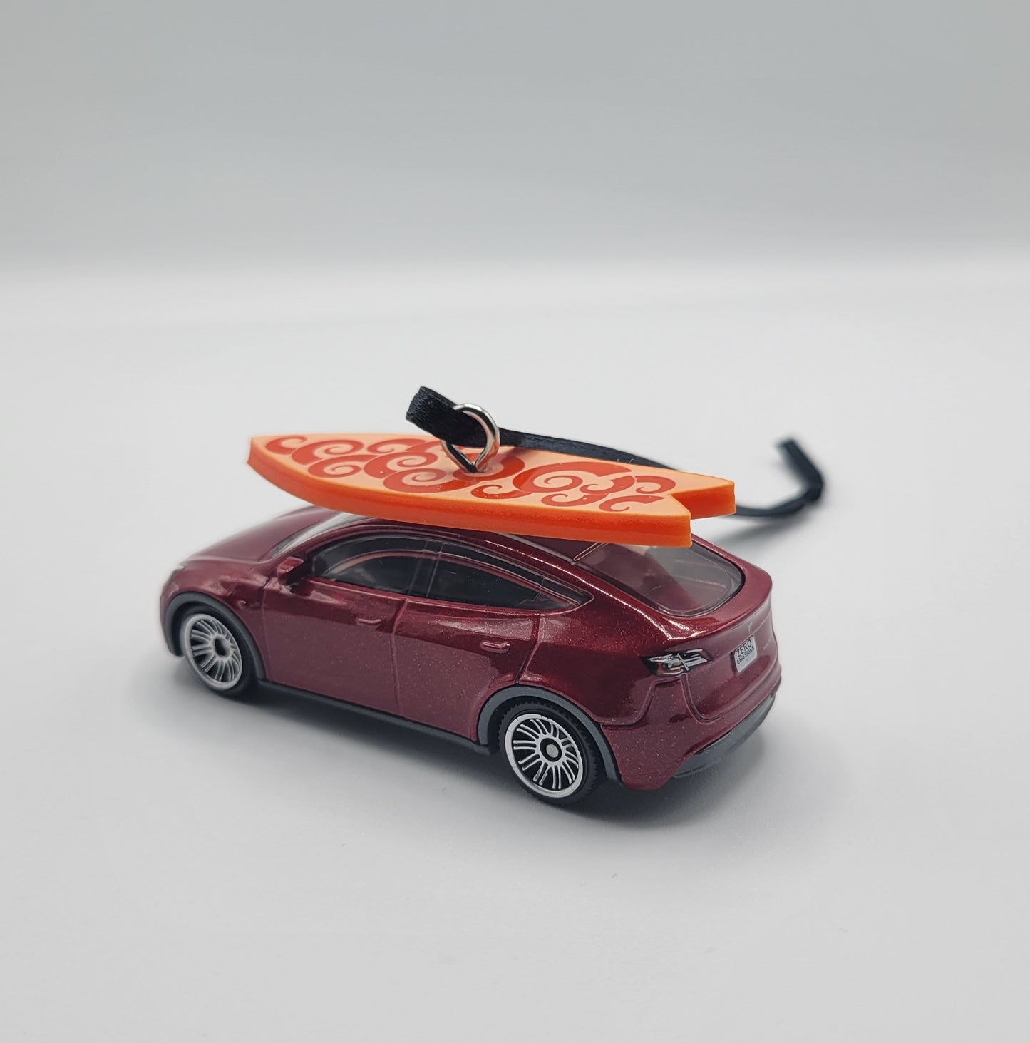Tesla Model Y Red Diecast Christmas Ornament with Surfboard on Roof – Color of Surfboard May Vary – Perfect Holiday Decoration for Car Enthusiasts